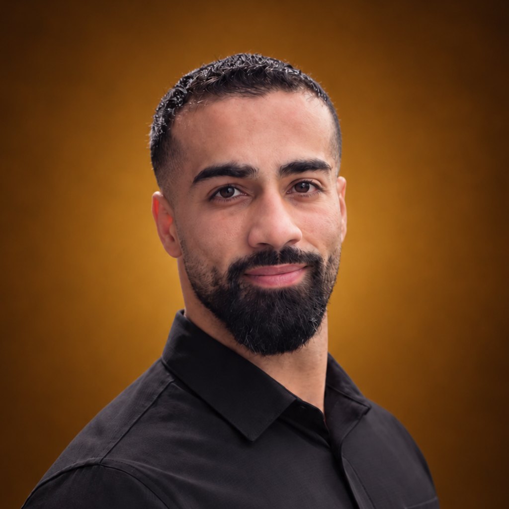 Portrait of Aladdin Hamed against a saffron-coloured background.